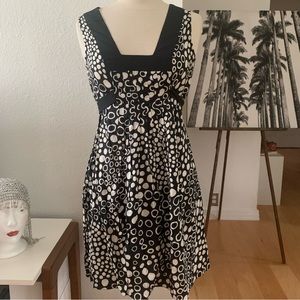 Le Lis Blanc Deux Sleeveless mini dress; black background with cream polka dots